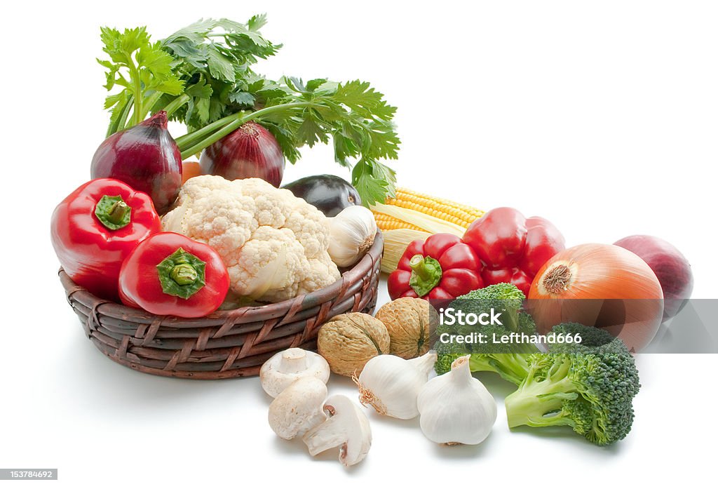 Vegetables Mix of fresh ripe vegetables arranged in a wicker basket and around isolated on white background Agriculture Stock Photo