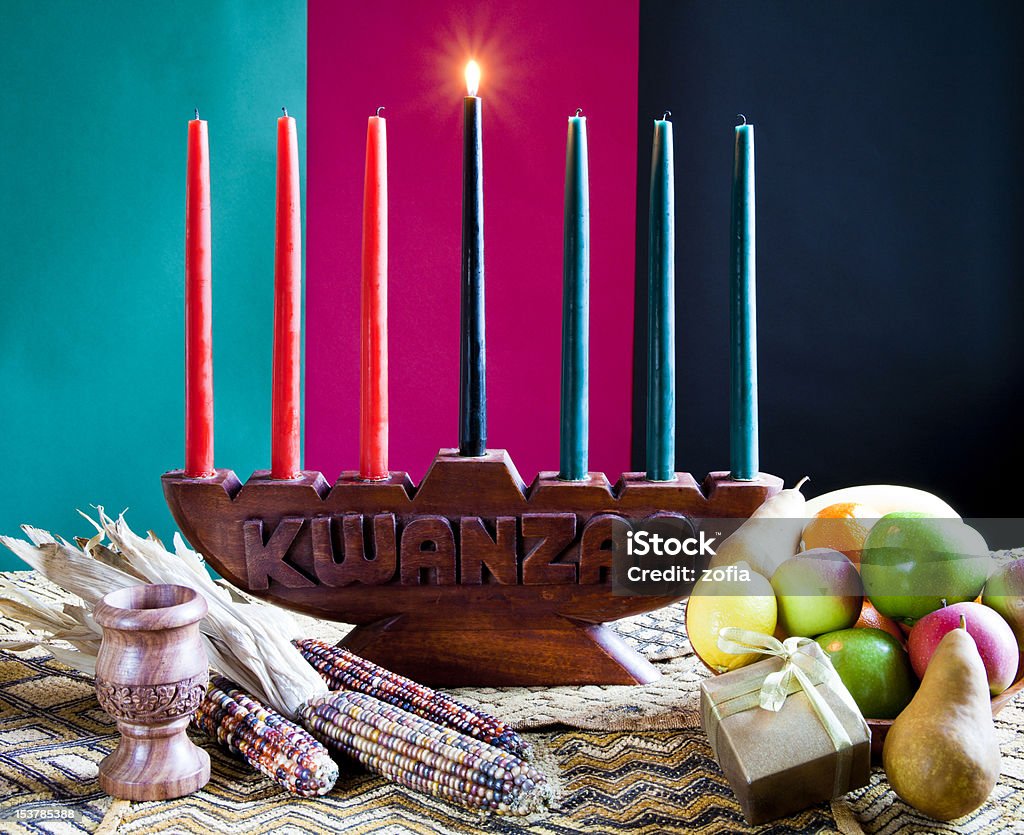 Seven colorful candles in celebration of Kwanzaa First Day of Kwanzaa , Umoja - Unity in Family, Community, Nation and Race , Way to Success.  Kwanzaa Stock Photo