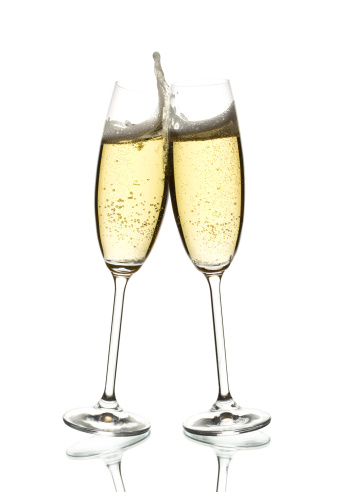 two glasses of sparkling wine, clinking, over white