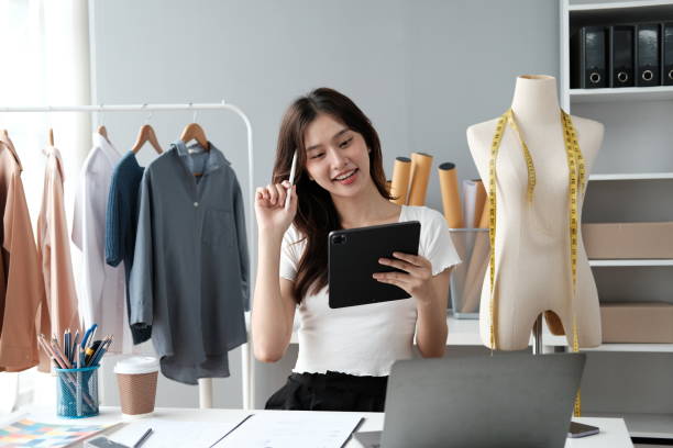 istock Asian female clothing designer working inside office. 1537859731