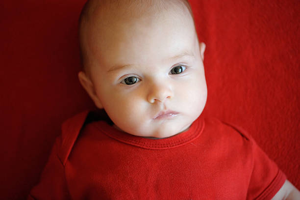 istock Two month baby laying on a red blanket 153786175