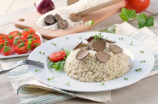 Truffle risotto Risotto with fresh black truffles and tomato salad tartuffo stock pictures, royalty-free photos & images