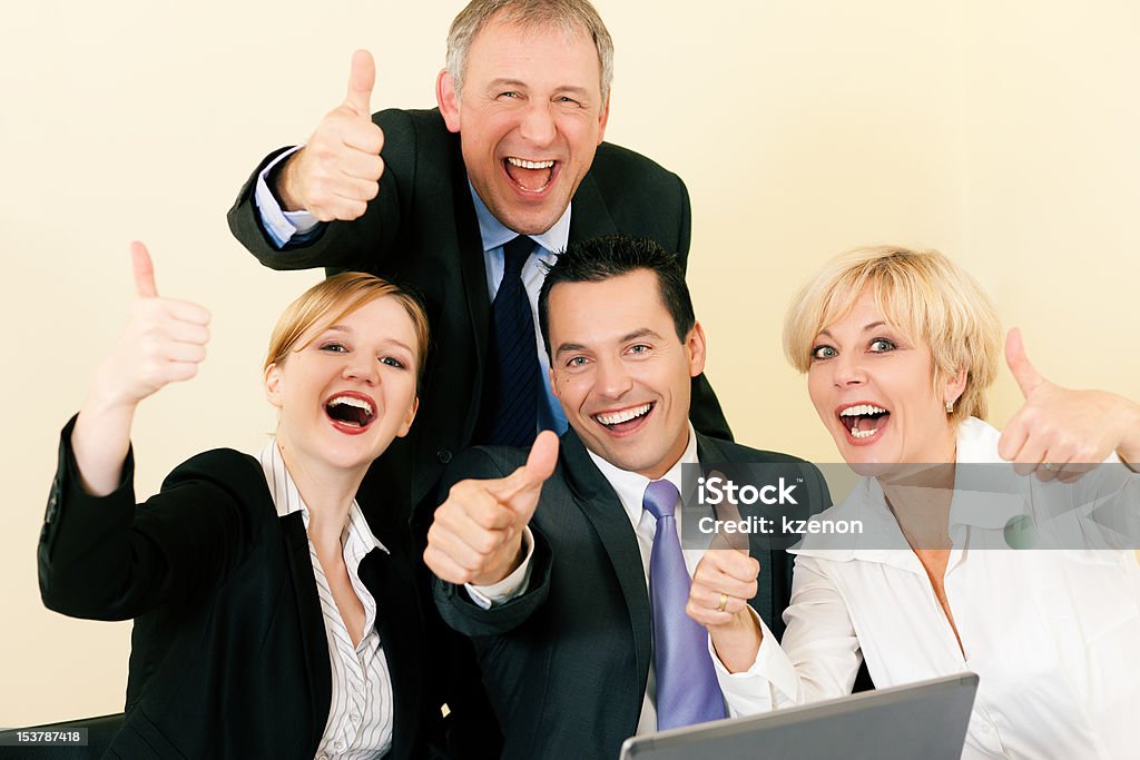 Businesspeople in office having great success Business people having a lot of fun and letting it show by doing the thumbs up sign, celebrating a success Adult Stock Photo