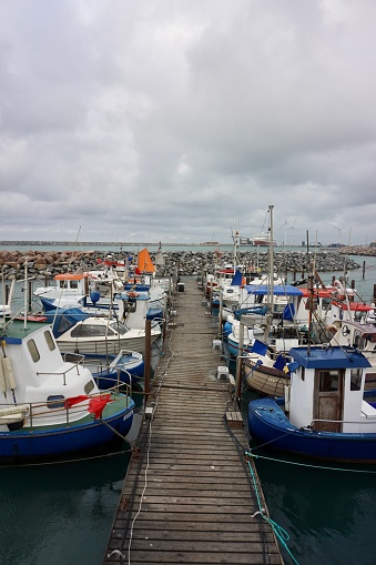 The port of Hirtshals in summer. Port in Denmark. A small port in Denmark, Hirtshals. Fishing vessels in the port of Hirtshals. The ships are parked in a row.