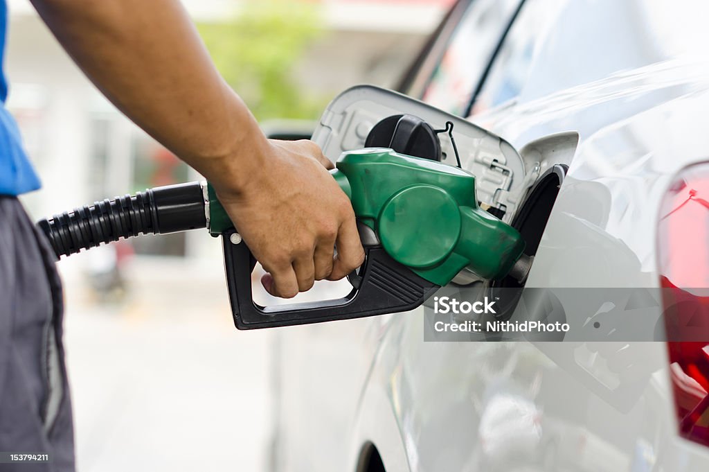 Refueling Car Refueling Car With Gasoline Pump Nozzle, Selective Focus on pump nozzle Gasoline Stock Photo
