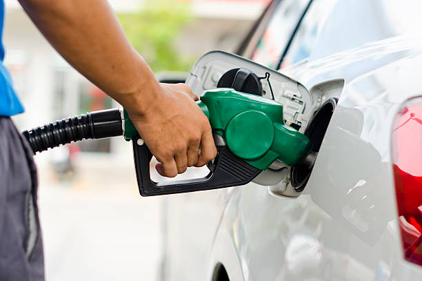 Refueling Car Refueling Car With Gasoline Pump Nozzle, Selective Focus on pump nozzle gasoline stock pictures, royalty-free photos & images