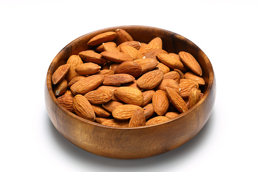 Fresh healthy Almond in bowl on isolated white background. Top view.