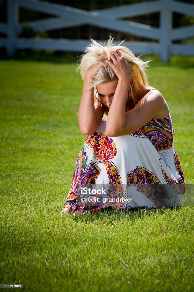 Beautiful Blond Portrait Sad portrait of pretty blond girl seated in chair outside 40-49 Years Stock Photo