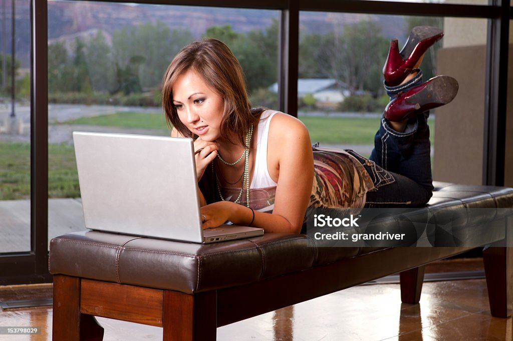 Young Woman Using Computer Young woman in a lobby of a college campus, office building or church using a laptop computer 20-29 Years Stock Photo