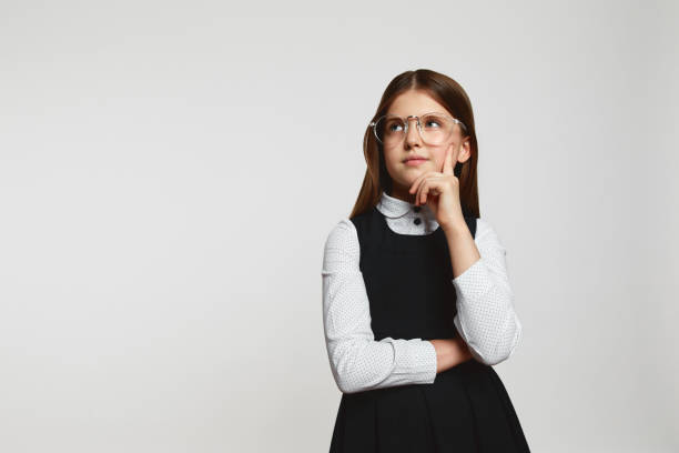 istock Girl standing with thoughtful serious smart expression, pondering answer having doubts and suspicion 1537981887