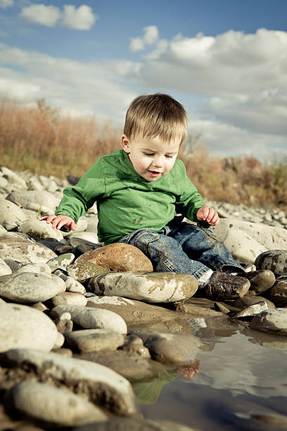 istock Toddler Boy Splashing in a pond 153800153