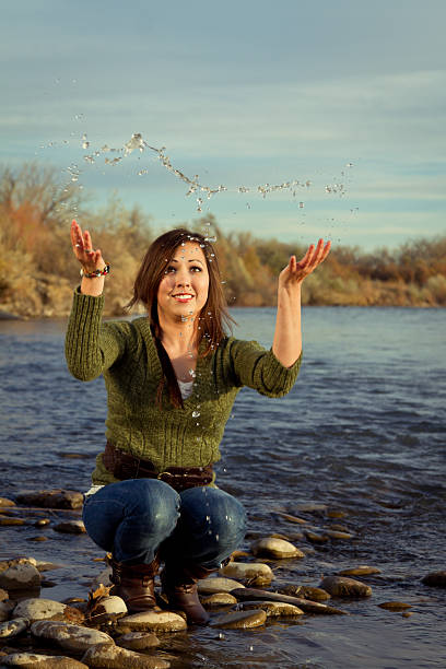 A beautiful woman is smiling on the river