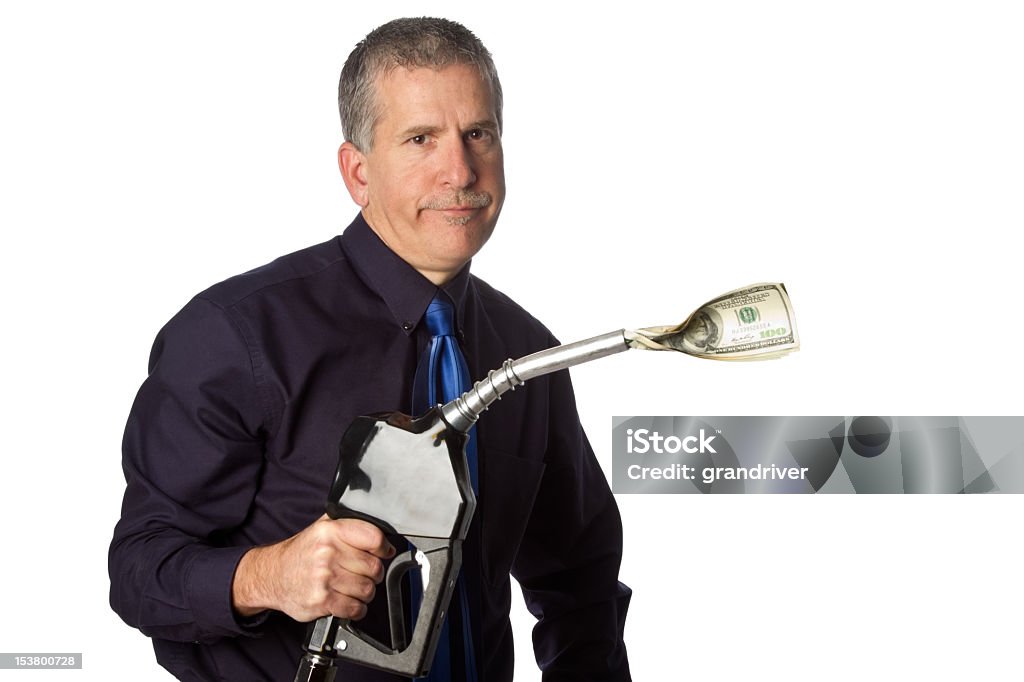 Man with Gasoline Nozzle and Cash Man posing in shirt and necktie with gasoline nozzle with wad of cash sticking out of it to signify high gasoline prices isolated in white Gas Station Stock Photo