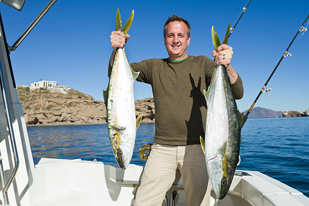 istock Fisherman with Tuna or Yellow Tail Mackeral Fish 153800819