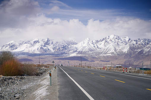 Snow Mountain Background Highway in Pamir Mountains,empty asphalt road with snow mountain