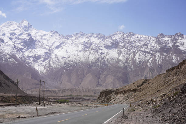 Snow Mountain Background Highway in Pamir Mountains,empty asphalt road with snow mountain Snow Mountain Background Highway in Pamir Mountains,empty asphalt road with snow mountain karakoram highway stock pictures, royalty-free photos & images