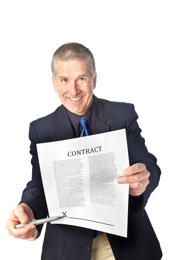 Smiling man gesturing to sign a contract, isolated on white