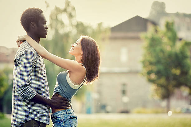 istock multi-ethnic young couple having fun at the park 153802592