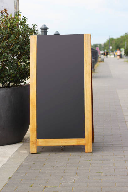 istock Empty black sandwich chalkboard menu board stand on a street. 1538035465