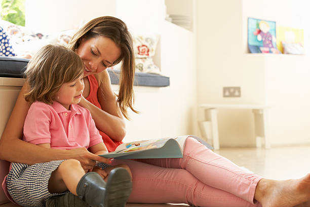 istock Mother Sitting With Son Reading Story Indoors 153803598