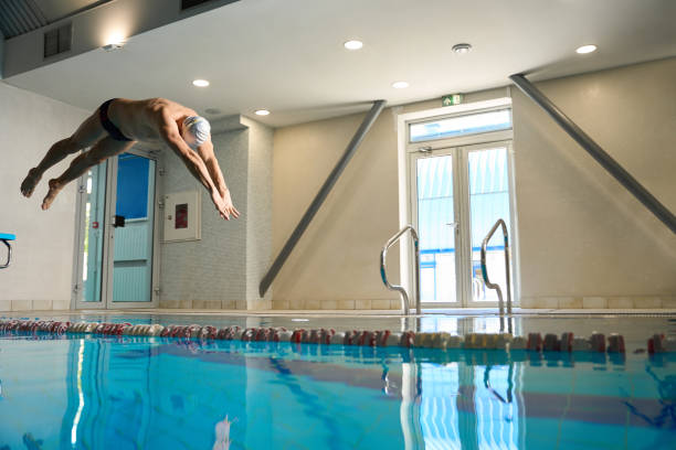 istock Male in white cap jumping into water 1538050590