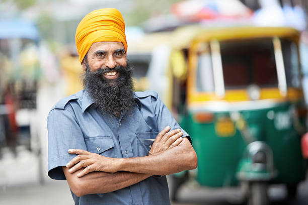 A smiling Indian rickshaw driver Indian auto rickshaw three-weeler tuk-tuk taxi driver man auto rickshaw taxi india stock pictures, royalty-free photos & images