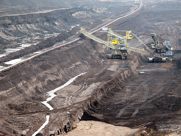 istock open Strip Coal mine with large excavators at conveyor belt 153805952