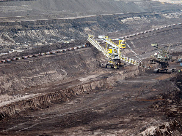 istock open Strip Coal mine with large excavators at conveyor belt 153805965