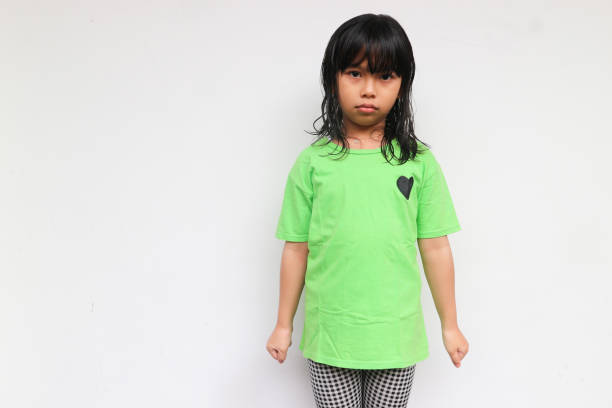 istock A girl with serious face looking at camera. Unhappy feeling concept 1538083819