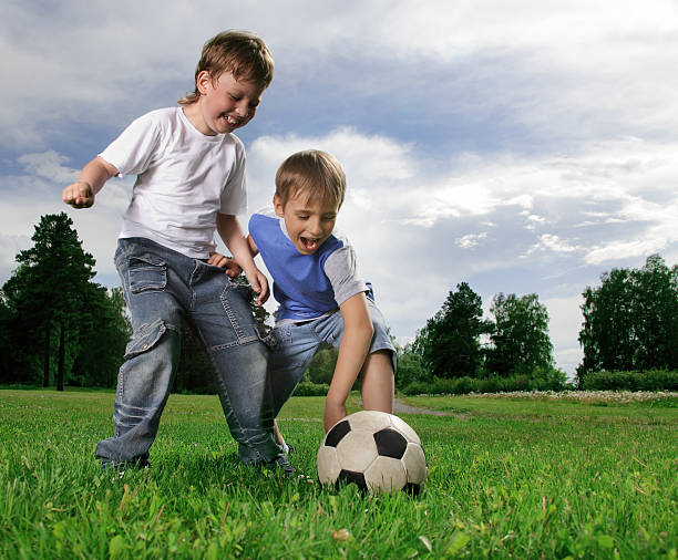 istock two happy boy play in soccer 153808660