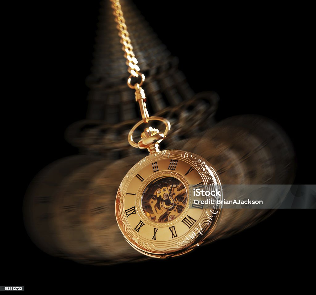 Hypnotizing pocket watch Hypnotism concept, gold pocket watch swinging used in hypnosis treatment Pendulum Stock Photo
