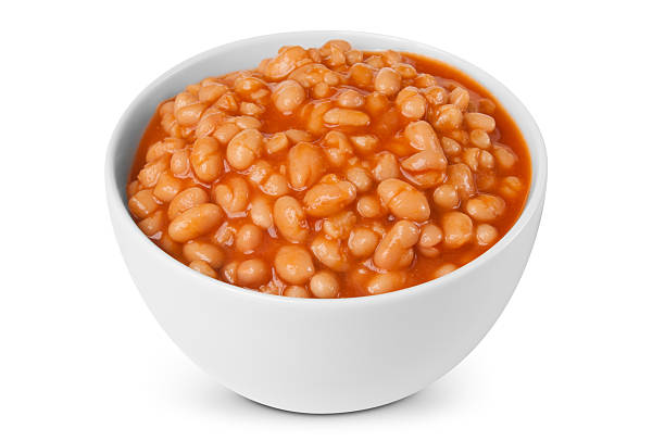 Baked beans in white bowl against white background stock photo