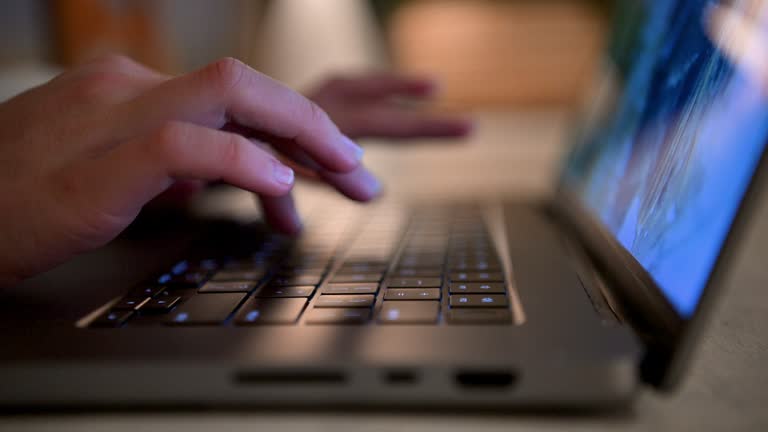 Close up of Woman opening a laptop and beginning to work.