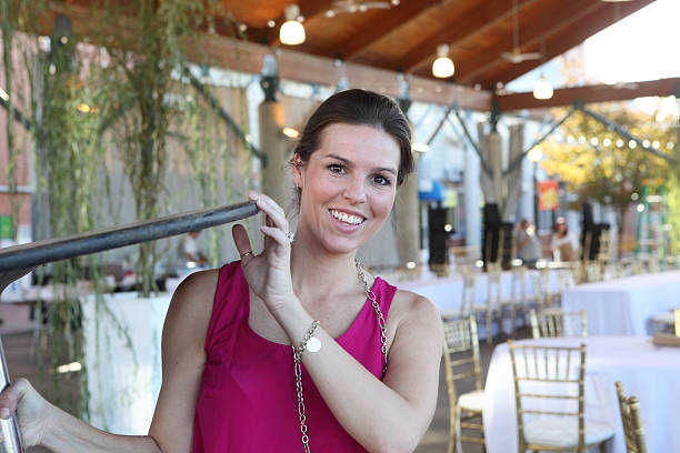 Young female smiling while setting up for a party stock photo
