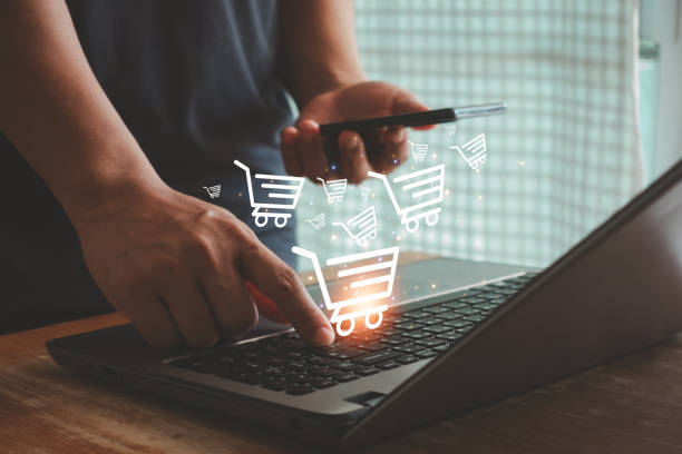 istock Seamless Online Shopping Experience. Businessman Using Mobile Phone and Laptop for E-commerce - Illustrating the Concept of Digital Commerce and Virtual Stores, Easy and Convenient Transactions. 1538140360
