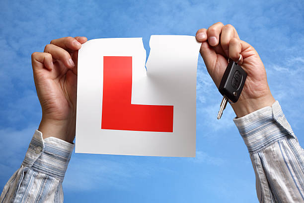 istock Tearing up L plate after passing driving test 153814181