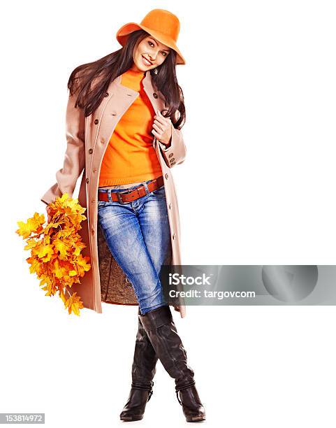 An Attractive Young Woman Holding Orange Leaves Stock Photo - Download Image Now - Autumn, Women, Clothing