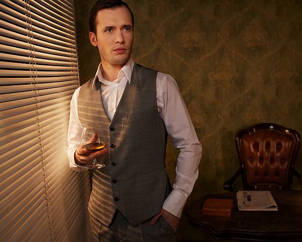 istock Retro man with a glass standing near window. 153818018