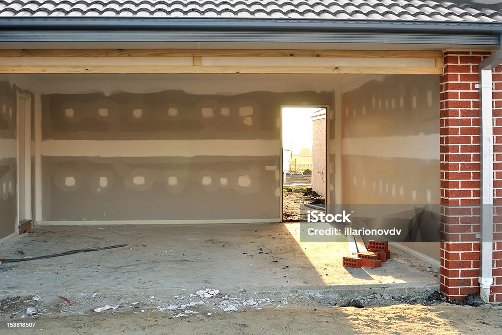 Light in garage Garage in house under construction, sunlight breaks trough open back door Architecture Stock Photo