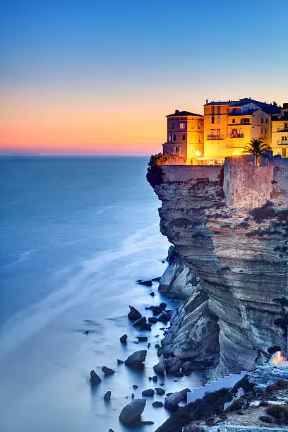 Twilight on the beautiful cliffs and buildings of Bonifacio, Corsica Island, France.