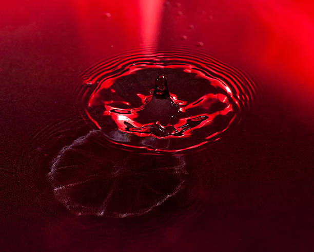 istock Red drop falls into a pool of water 153819701