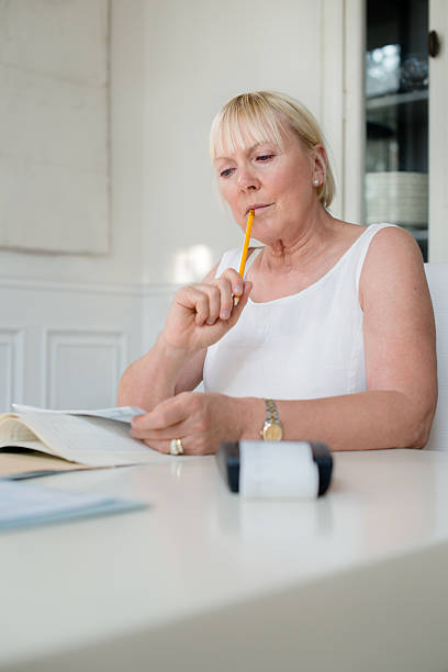 istock Mature woman checking bills and doing budget at home 153822613
