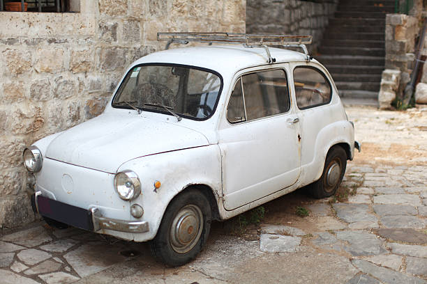istock Old-timer white small italian car parked in an alley 153824365