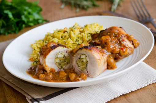 Stuffed chicken thighs in an aromatic spiced tagine sauce with carrot pilau rice