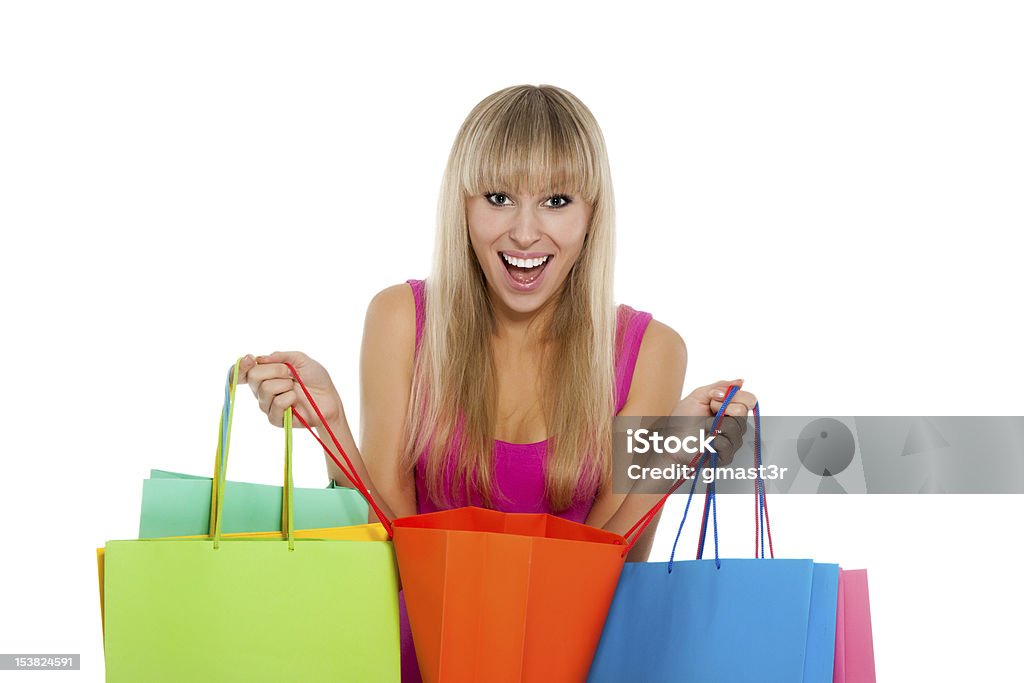 woman shopping Portrait of happy smile beautiful woman with colorful shopping bags in her hands, girl wear sexy pink dress, isolated over white background 20-29 Years Stock Photo