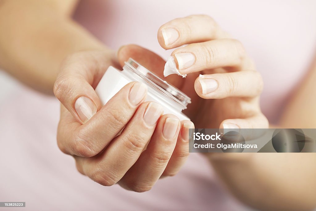 beautiful woman hands applying cream Hand Cream Stock Photo