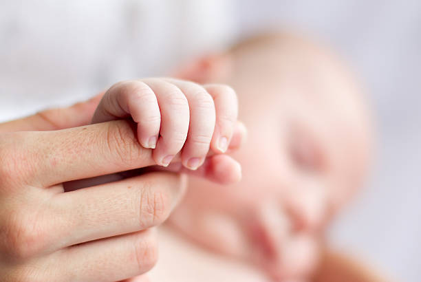 istock Close up of babies fingers 153825612