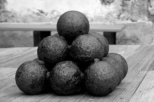 14 cannon balls stacked in a pyramid.