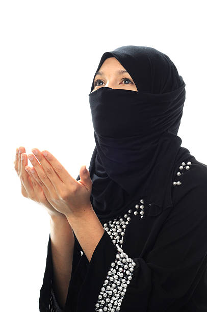 istock Muslim women pray looking up from side prespective 153828007