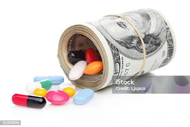 Money Rolled Up With Pills Flowing Out Stock Photo - Download Image Now - Capsule - Medicine, Close-up, Closed